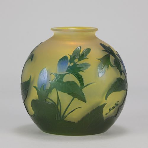 fig 6. A spherical Art Nouveau cameo glass vase featuring green and blue etched bellflowers over a frosted yellow background.