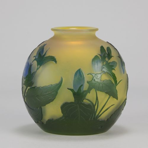 fig 7. A spherical Art Nouveau cameo glass vase featuring green and blue etched bellflowers over a frosted yellow background.