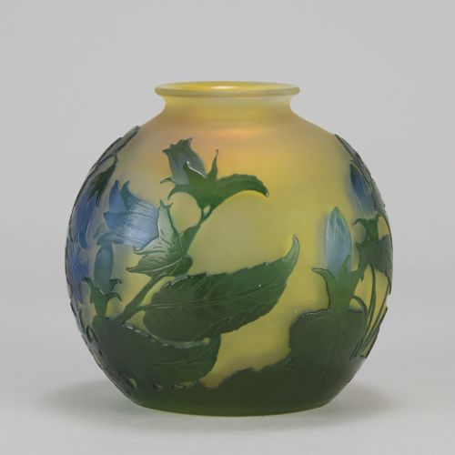 fig 8. A spherical Art Nouveau cameo glass vase featuring green and blue etched bellflowers over a frosted yellow background.