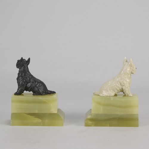 fig 4. Pair of antique cold-painted bronze terrier dogs mounted on stepped green onyx bookend bases.
