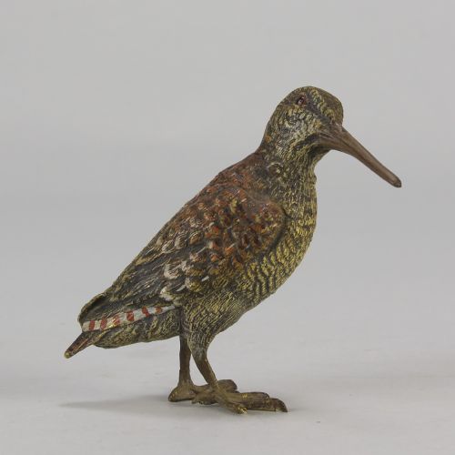 fig 1. An early 20th-century cold-painted bronze figure of a woodcock bird standing with textured plumage and a long beak.