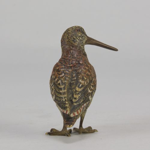 fig 3. An early 20th-century cold-painted bronze figure of a woodcock bird standing with textured plumage and a long beak.