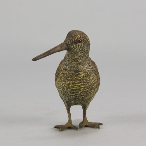 fig 6. An early 20th-century cold-painted bronze figure of a woodcock bird standing with textured plumage and a long beak.