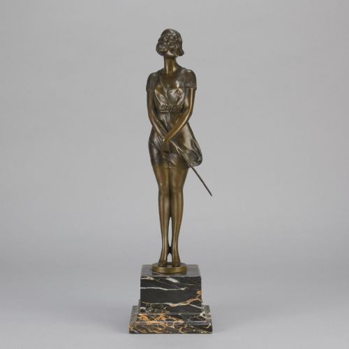 fig 1. An Art Deco bronze statue of a standing woman holding a crop, mounted on a square black marble pedestal.