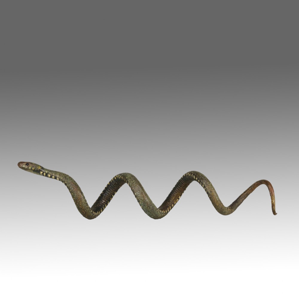 An early 20th-century Viennese cold-painted bronze figure depicting a coiled snake with realistic scale detail.