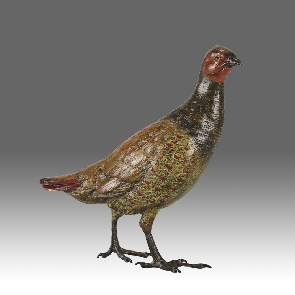 A cold-painted bronze sculpture depicting a standing grouse bird with detailed feather texturing in brown, red, and green tones.