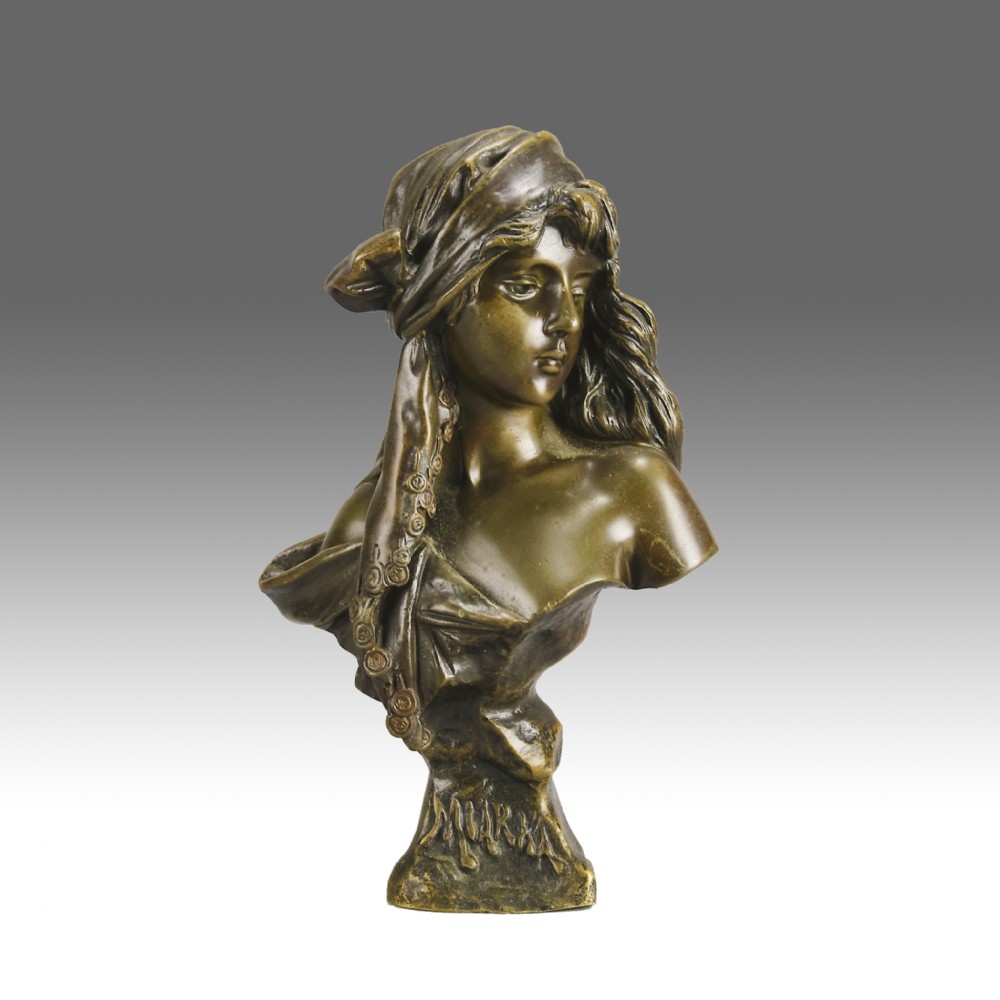 A patinated bronze Art Nouveau bust depicting a young woman wearing a headscarf with draped coins, titled Miarka at the base.