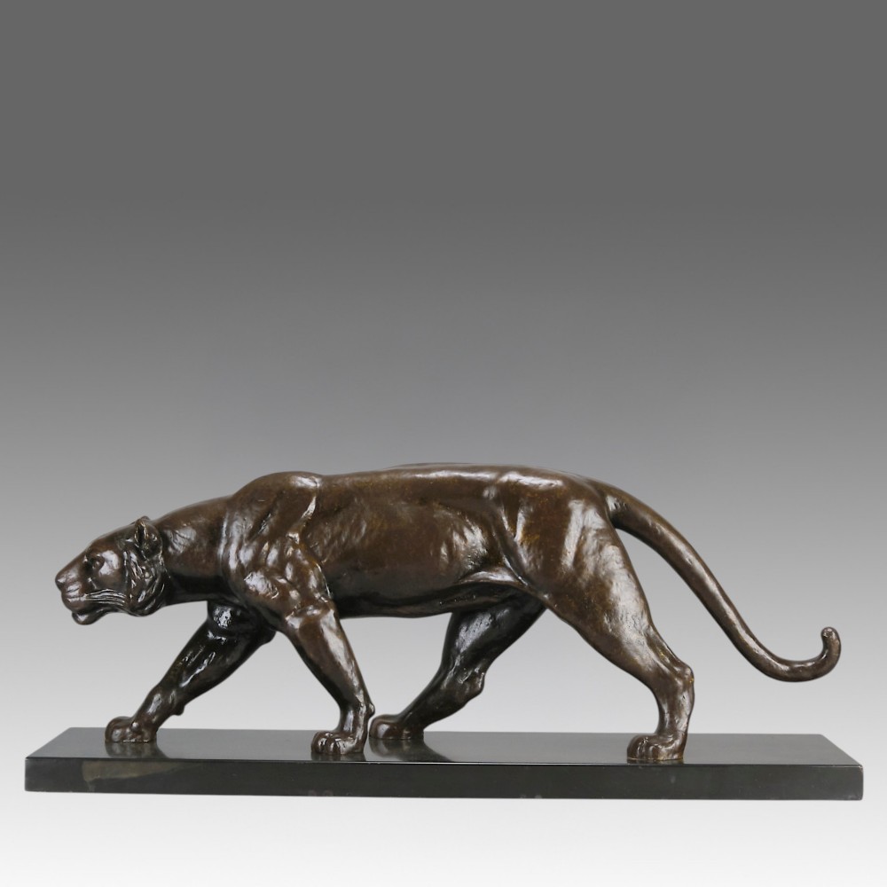 An Art Deco dark bronze sculpture of a muscular stalking panther mounted on a thin rectangular dark marble base.