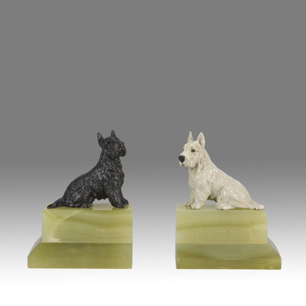 Pair of antique cold-painted bronze terrier dogs mounted on stepped green onyx bookend bases.