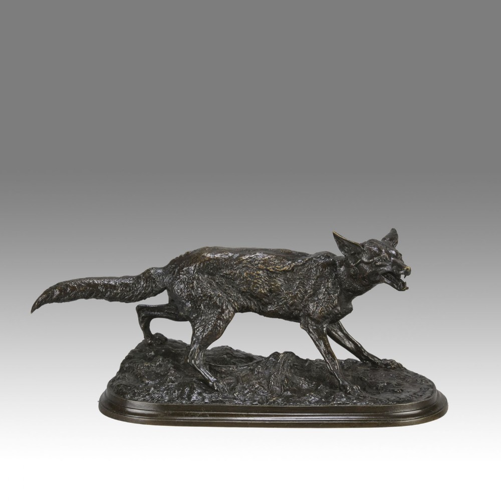 A late nineteenth-century dark brown patinated bronze sculpture depicting a snarling fox prowling across a naturalistic base.