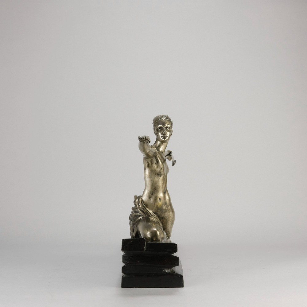 An Art Deco silvered metal sculpture depicting a stylized female archer holding a spear, mounted on a stepped black base. View IV