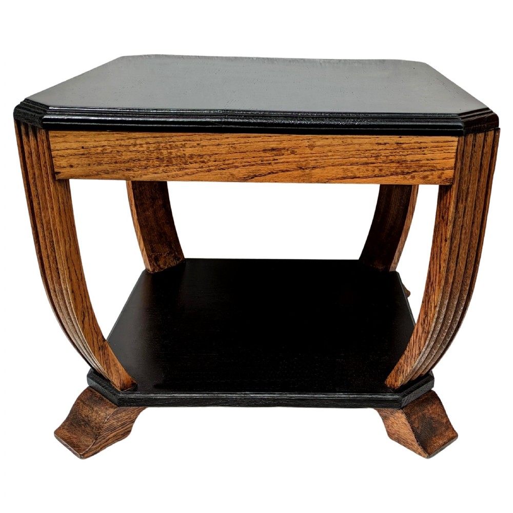 An Art Deco two-tiered occasional table featuring an ebonised black top surface and lower shelf contrasted with solid oak reeded legs. View V