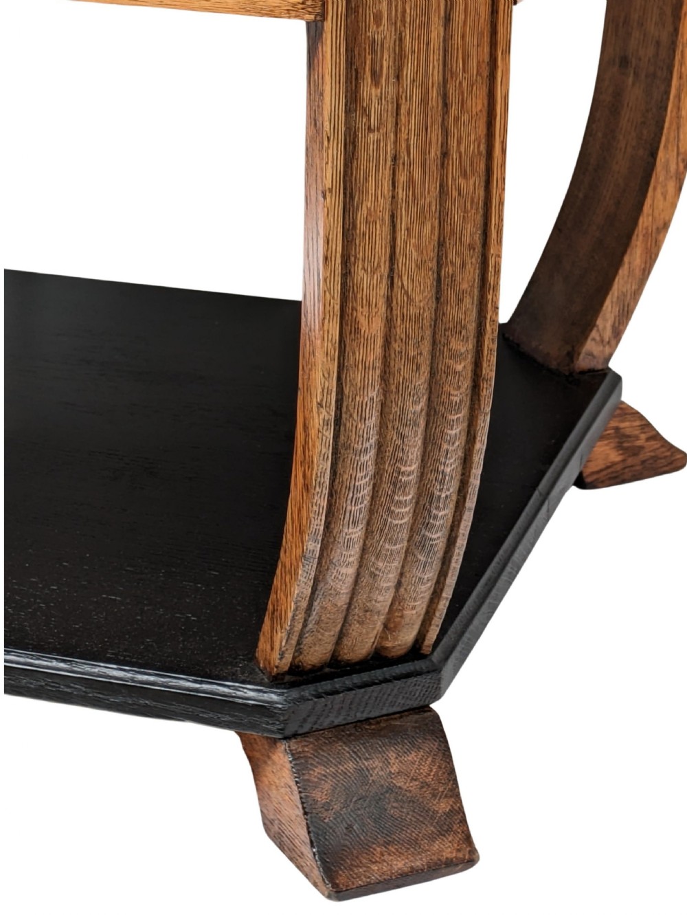 An Art Deco two-tiered occasional table featuring an ebonised black top surface and lower shelf contrasted with solid oak reeded legs. View II
