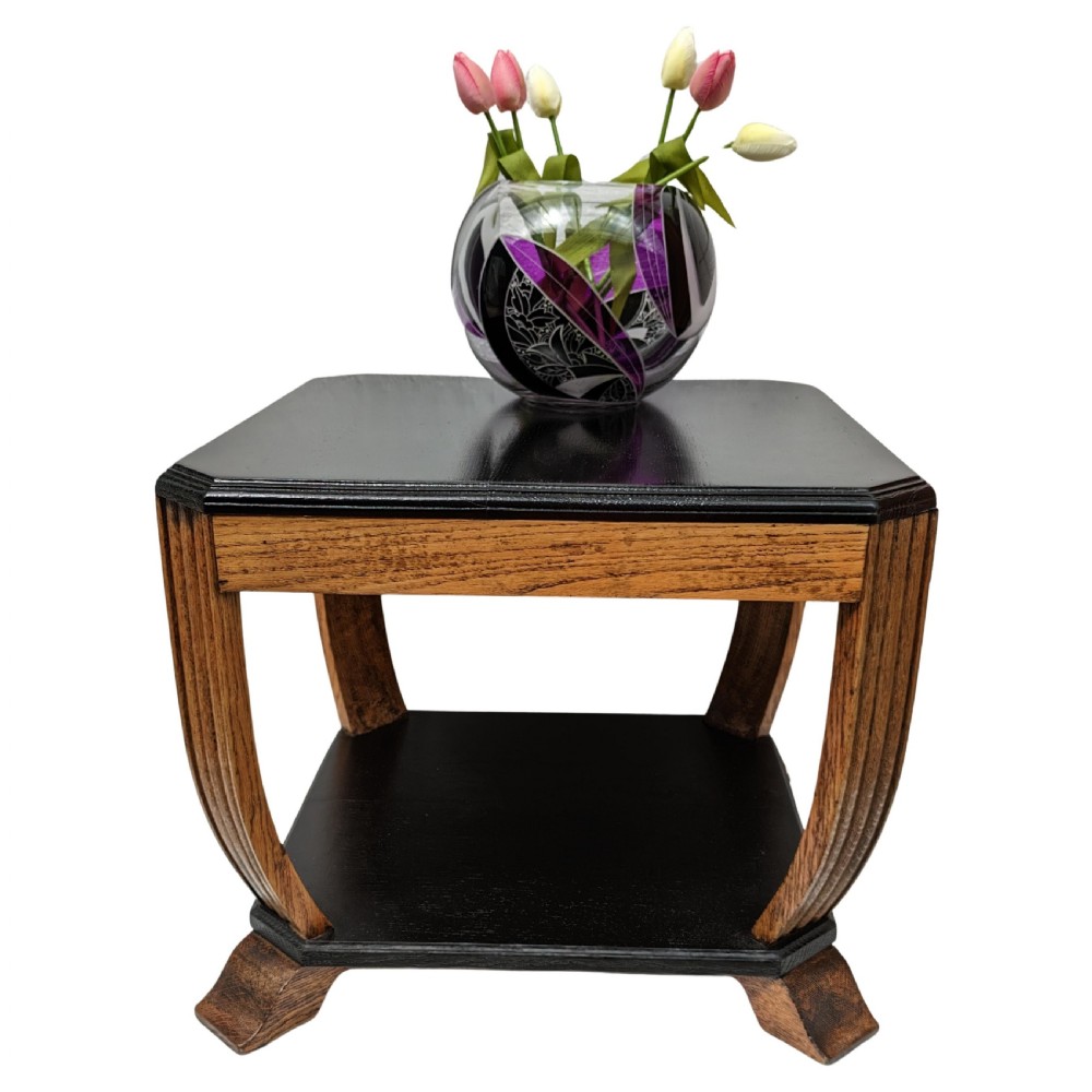 An Art Deco two-tiered occasional table featuring an ebonised black top surface and lower shelf contrasted with solid oak reeded legs. View VI