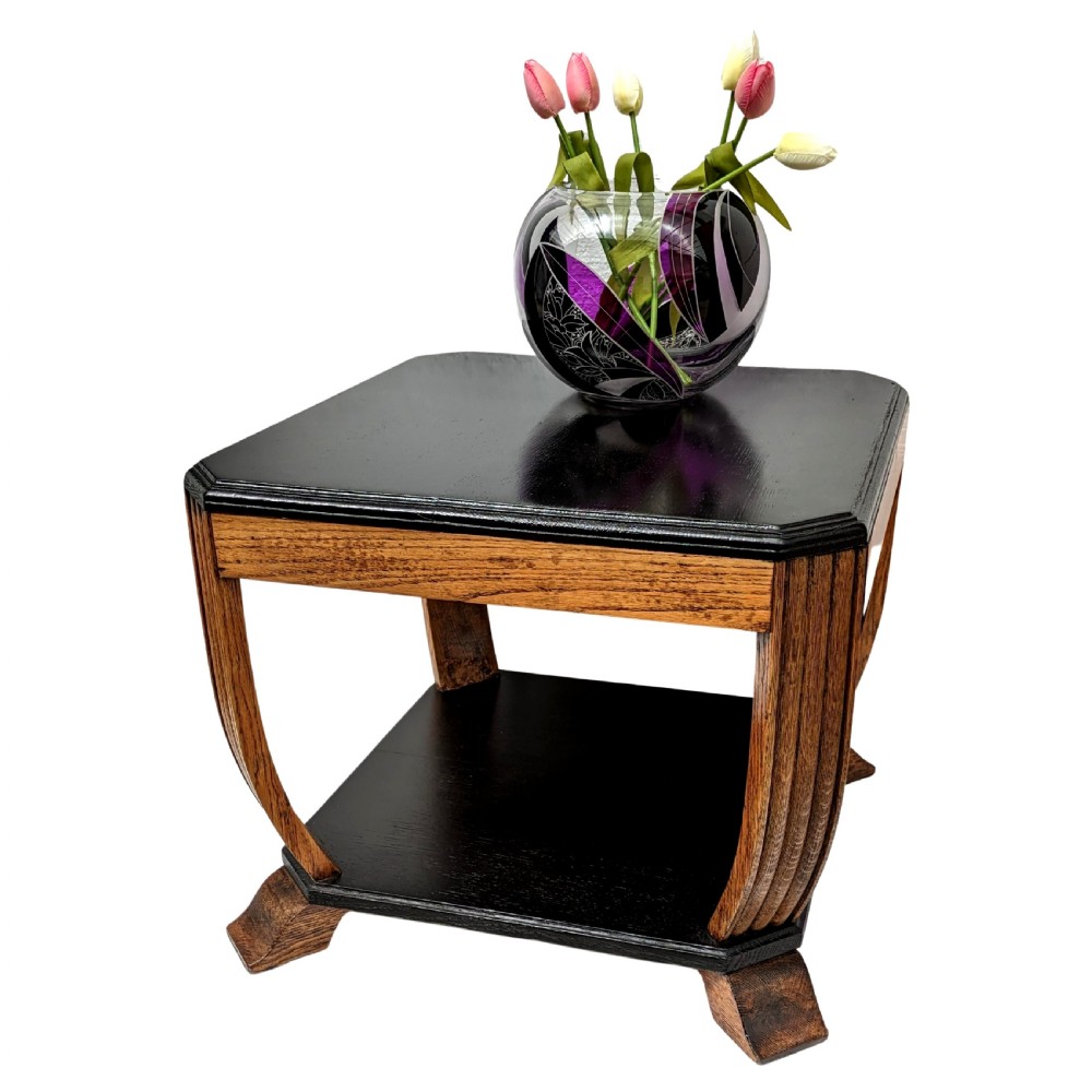 An Art Deco two-tiered occasional table featuring an ebonised black top surface and lower shelf contrasted with solid oak reeded legs. View VII