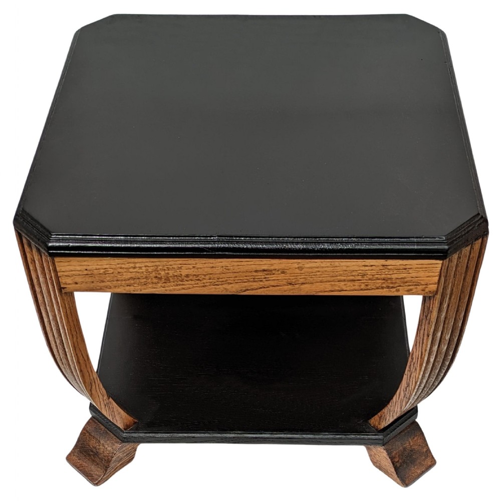 An Art Deco two-tiered occasional table featuring an ebonised black top surface and lower shelf contrasted with solid oak reeded legs. View VIII