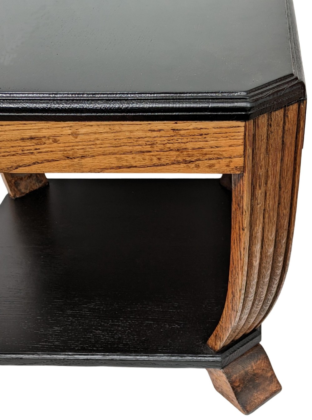 An Art Deco two-tiered occasional table featuring an ebonised black top surface and lower shelf contrasted with solid oak reeded legs. View IX