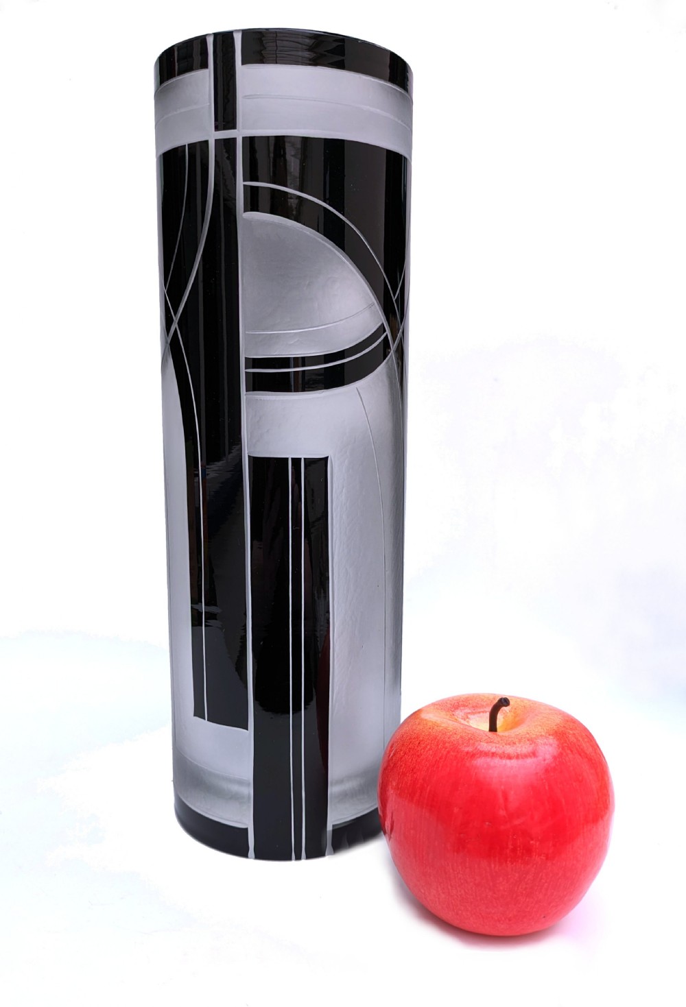 A tall cylindrical Art Deco glass vase featuring black abstract geometric lines against a frosted glass background. View IV