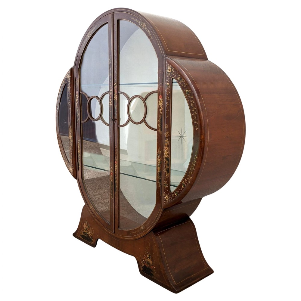 A 1930s Art Deco mahogany display cabinet featuring a circular silhouette with hand-painted gilt Chinoiserie details and glazed double doors. View III