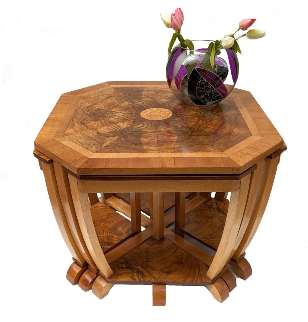 An octagonal 1930s Art Deco walnut nest of tables featuring quarter-matched burr walnut veneer top and four fitted triangular side tables.