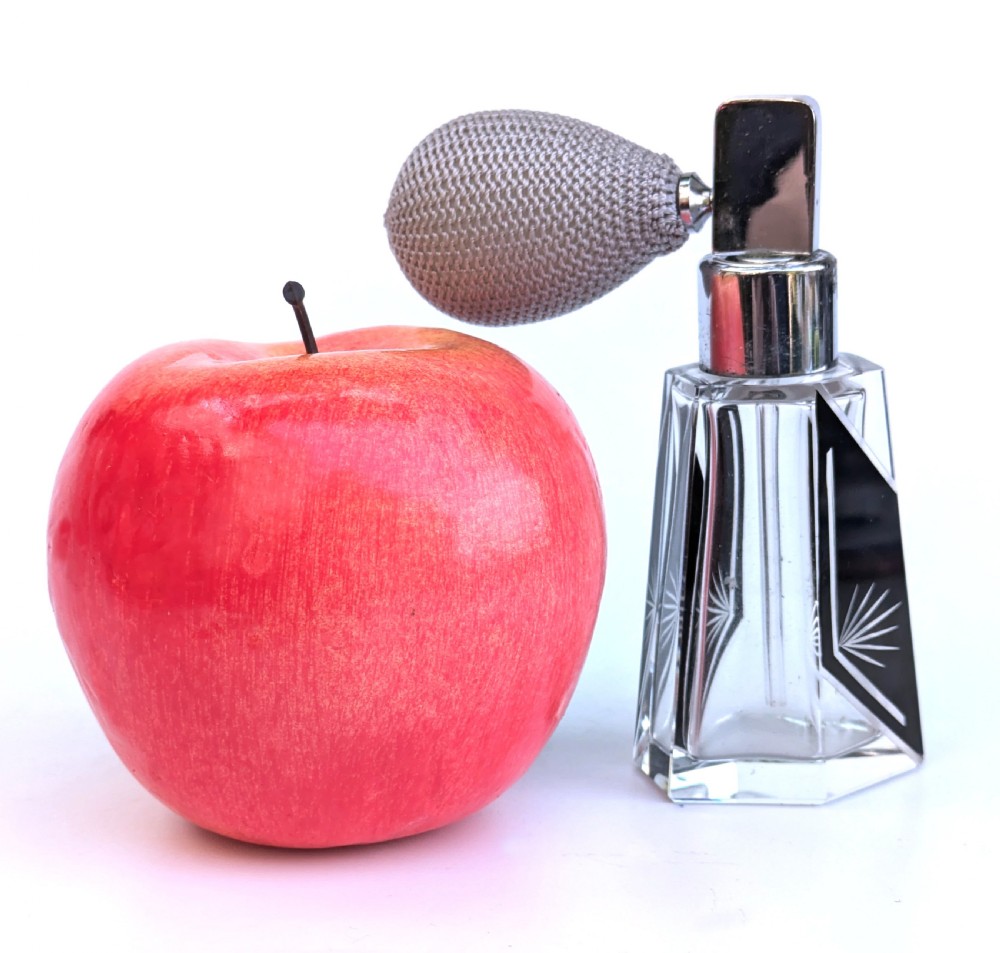 A geometric clear glass Art Deco perfume atomiser bottle featuring black enamel panels, etched sunburst motifs, a chrome spray nozzle, and a grey woven fabric bulb. View II