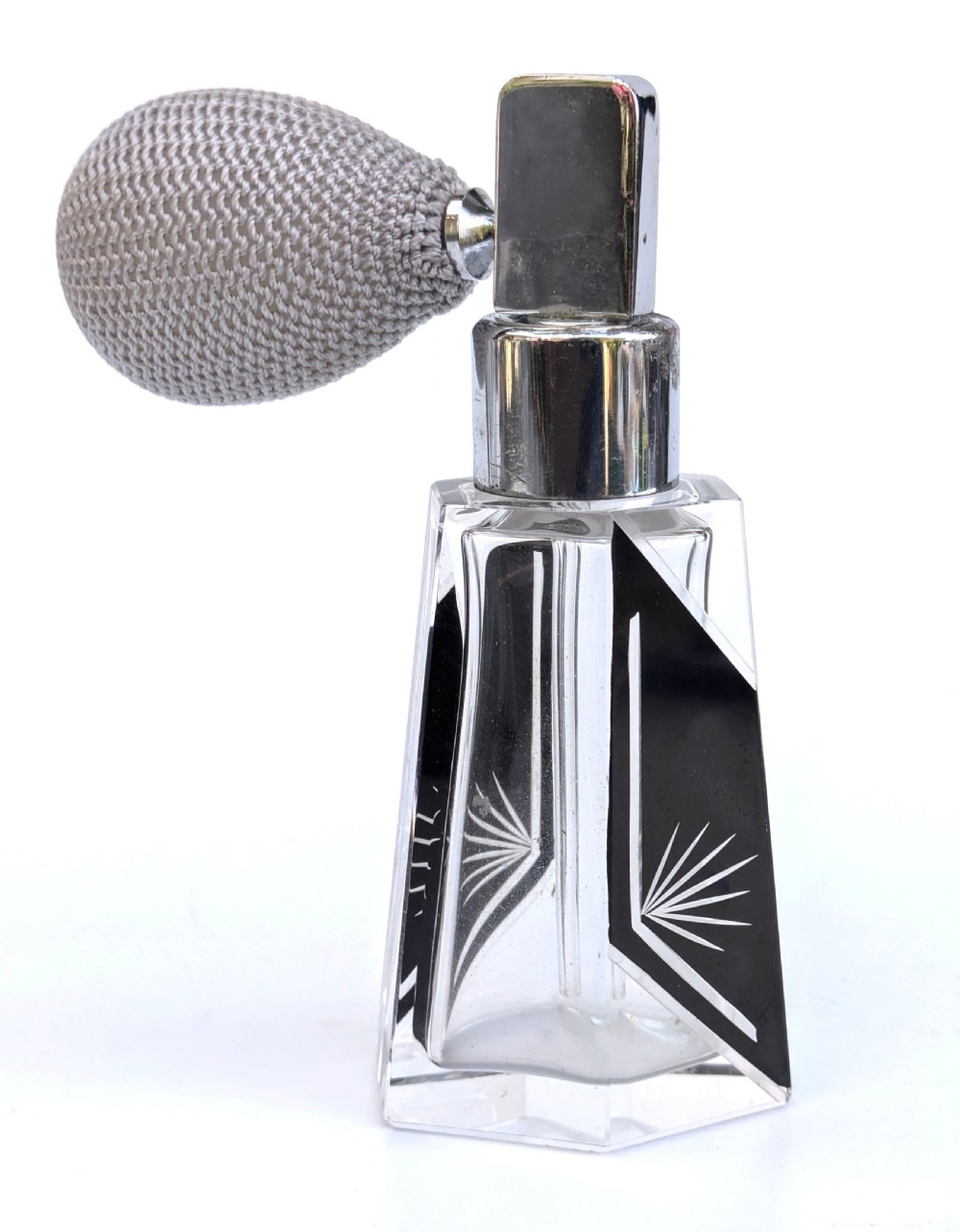 A geometric clear glass Art Deco perfume atomiser bottle featuring black enamel panels, etched sunburst motifs, a chrome spray nozzle, and a grey woven fabric bulb. View III