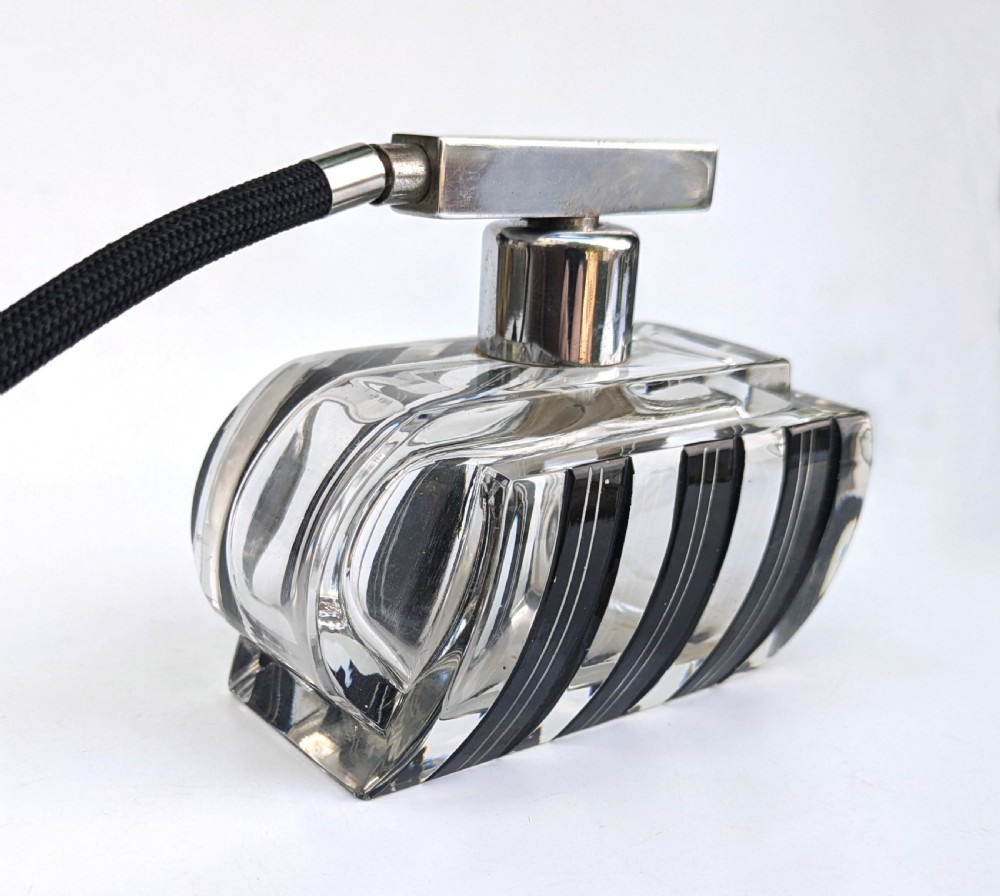 An Art Deco clear glass perfume atomiser featuring painted black geometric stripes, chrome metal hardware, and a black fabric squeeze bulb with a long tassel. View V