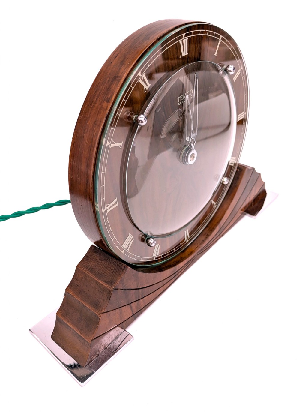 An Art Deco circular walnut mantel clock featuring inlaid Roman numerals and a stepped contoured base. View III