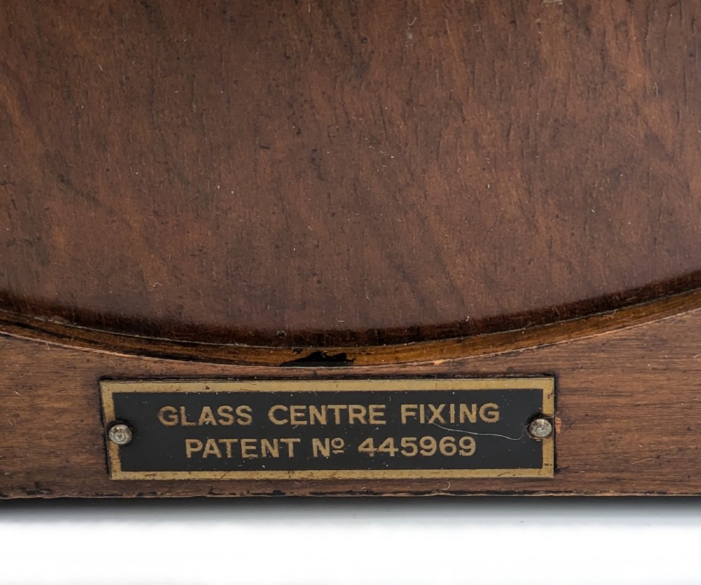 An Art Deco circular walnut mantel clock featuring inlaid Roman numerals and a stepped contoured base. View VIII