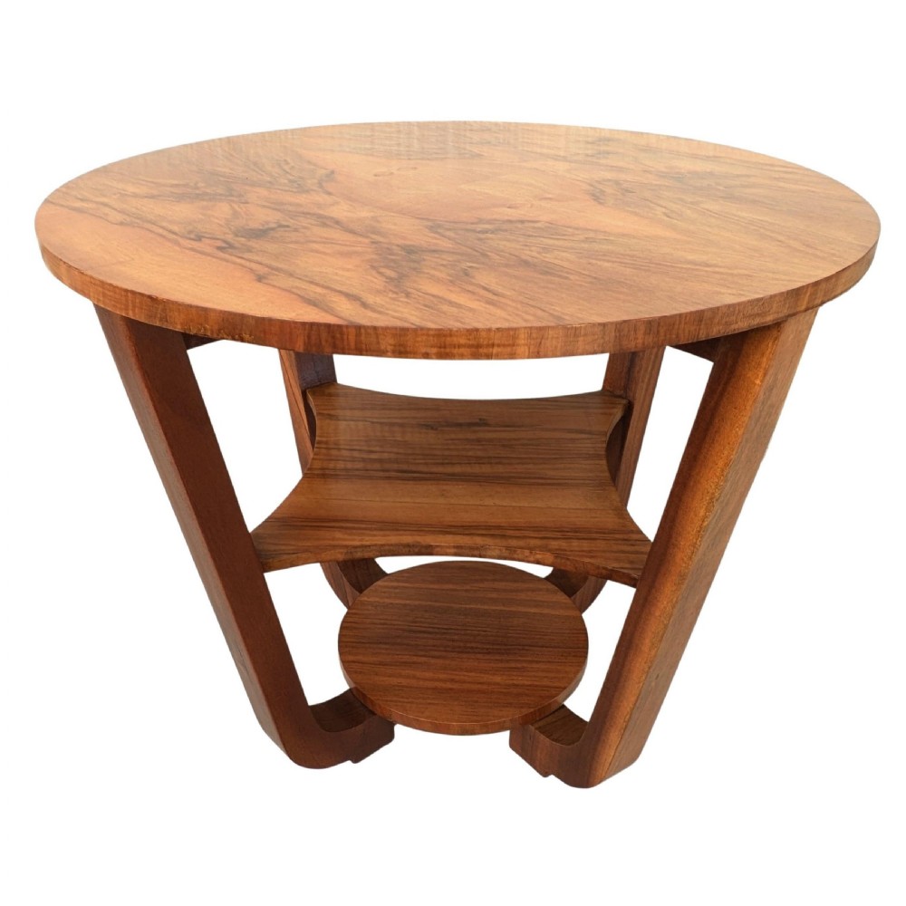 An Art Deco circular walnut occasional table featuring three tiers and angled wooden supports, showing rich grain patterns. View V