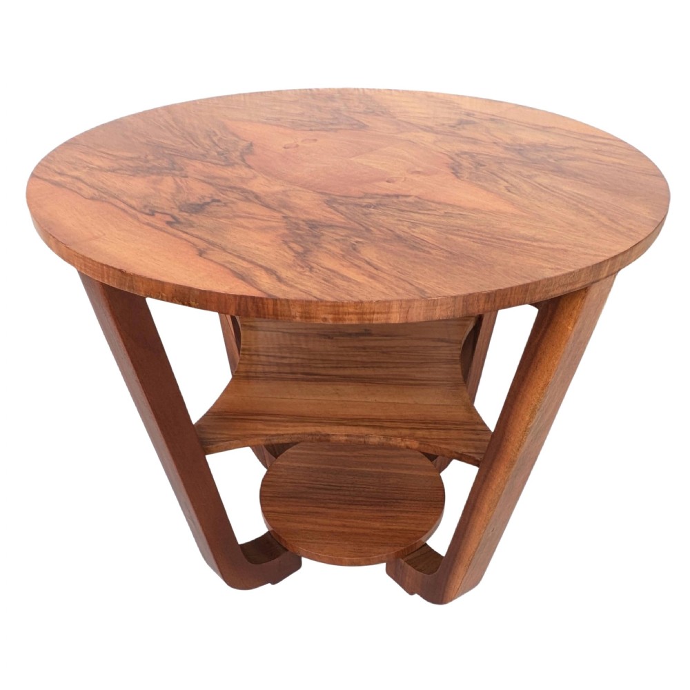 An Art Deco circular walnut occasional table featuring three tiers and angled wooden supports, showing rich grain patterns. View VIII