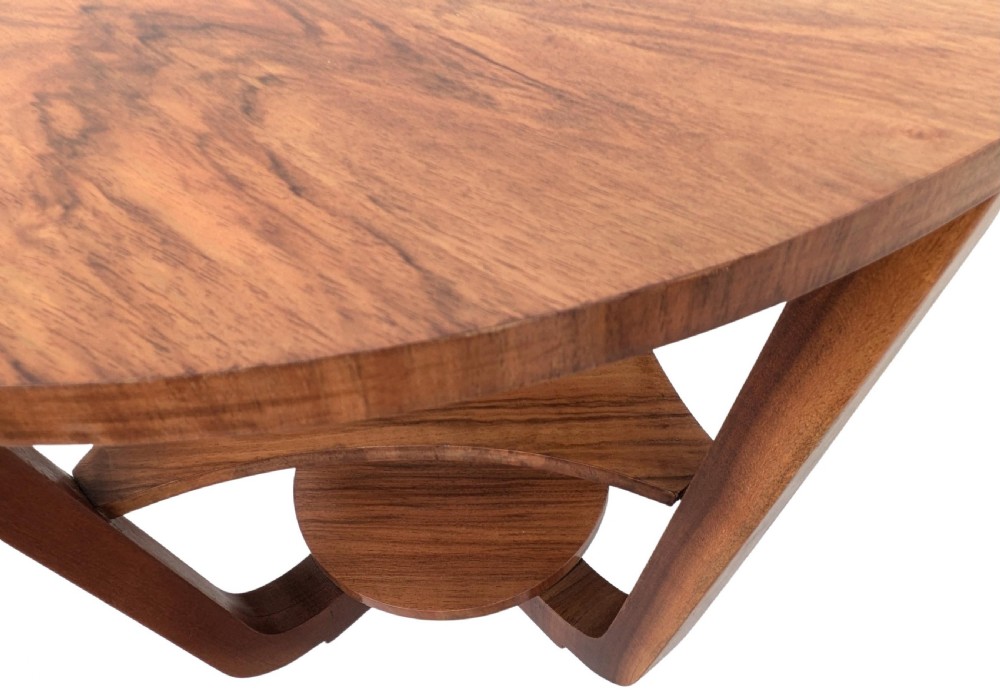 An Art Deco circular walnut occasional table featuring three tiers and angled wooden supports, showing rich grain patterns. View IX