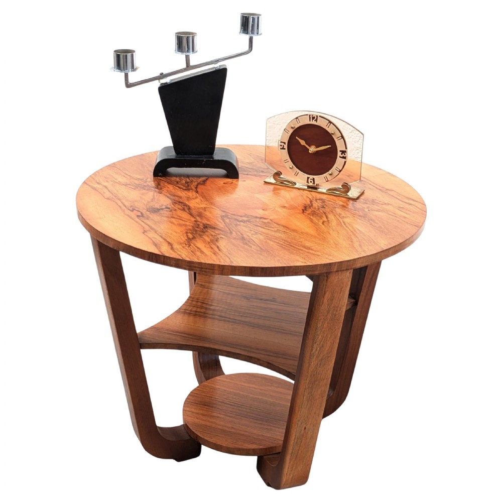 An Art Deco circular walnut occasional table featuring three tiers and angled wooden supports, showing rich grain patterns. View XI