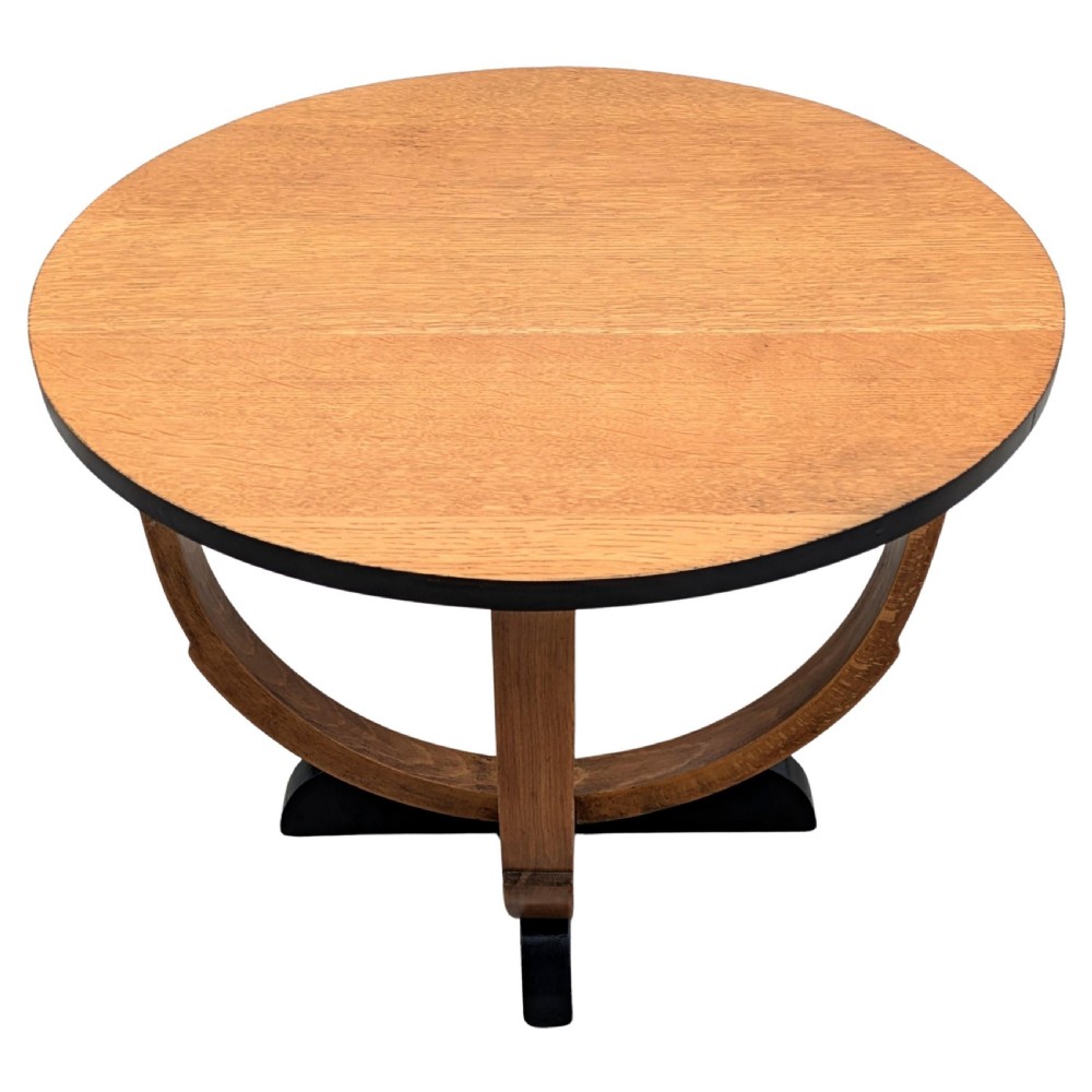A round Art Deco blonde oak coffee table featuring sweeping curved legs and contrasting ebonised rim and cross base. View III