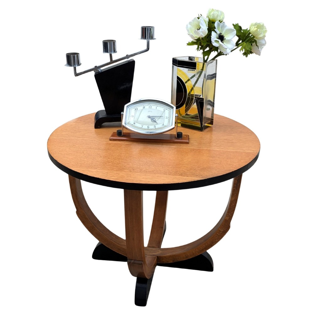 A round Art Deco blonde oak coffee table featuring sweeping curved legs and contrasting ebonised rim and cross base. View V