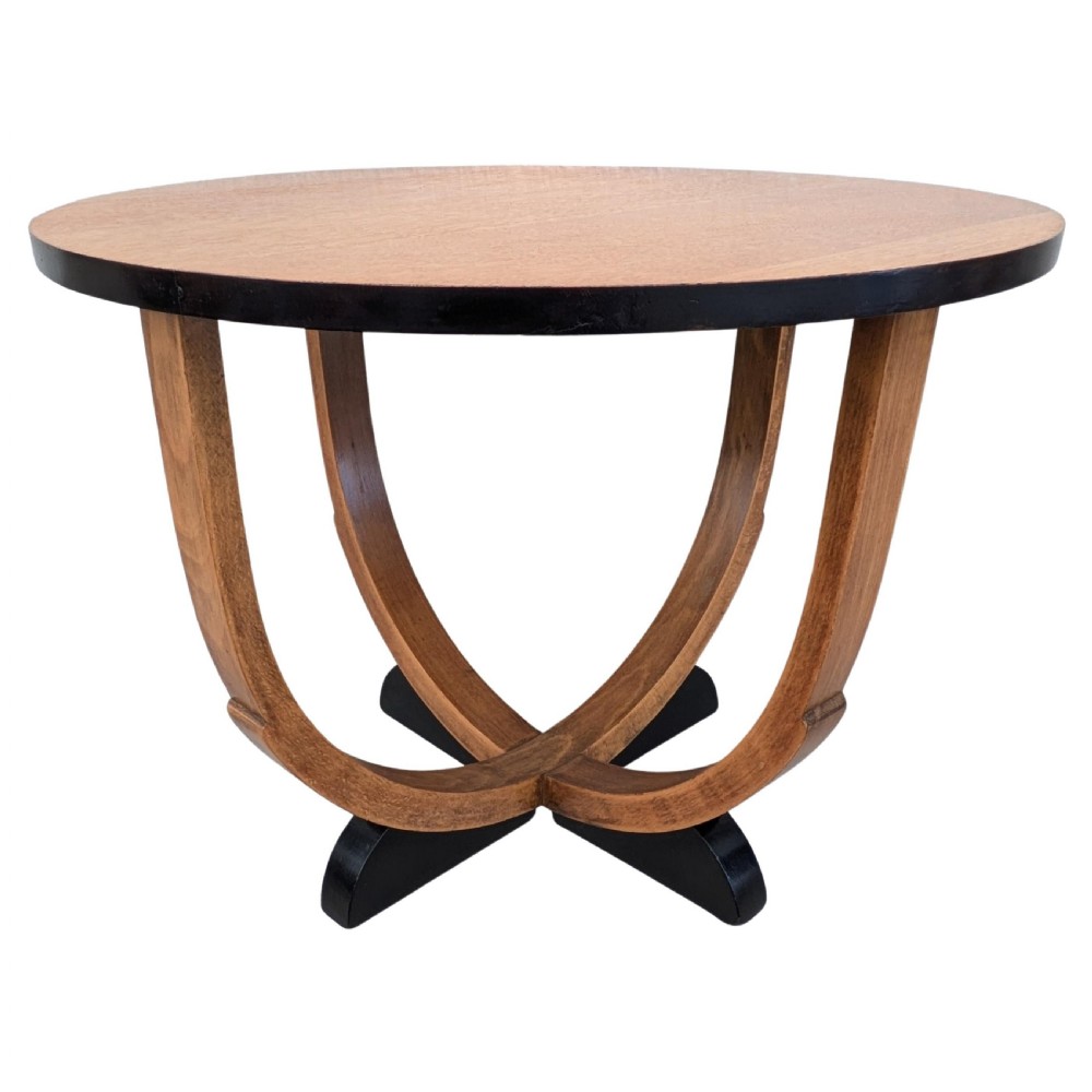 A round Art Deco blonde oak coffee table featuring sweeping curved legs and contrasting ebonised rim and cross base. View VIII