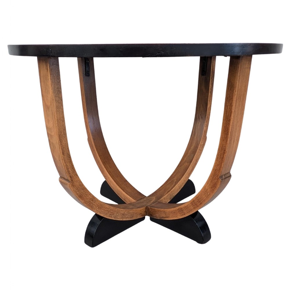 A round Art Deco blonde oak coffee table featuring sweeping curved legs and contrasting ebonised rim and cross base. View IX