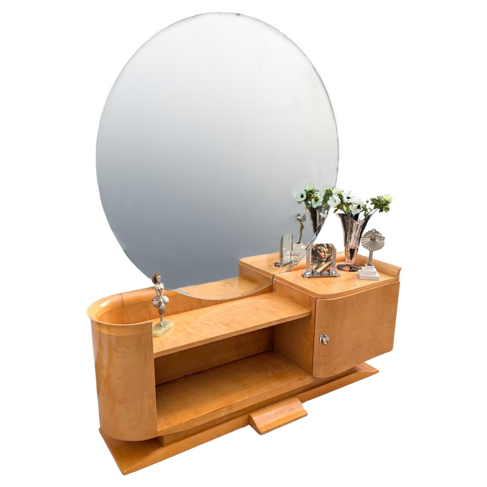 A 1930s Art Deco blonde wood dressing table featuring a massive circular mirror, asymmetrical open shelving, and a curved side pedestal cabinet. View III