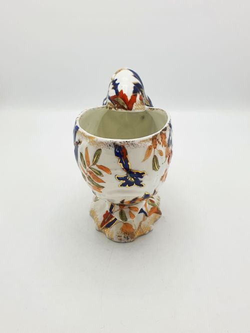 fig 2. A late Victorian Ridgways china spoon warmer in the shape of a nautilus shell with cobalt blue, terracotta orange floral details, and gilded trim.