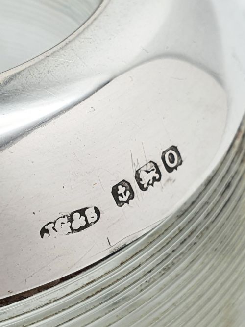 fig 1. A spherical clear ribbed glass match striker featuring a hallmarked sterling silver collar around the top rim.