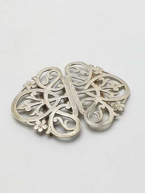 fig 1. An Edwardian two-part sterling silver belt buckle featuring pierced scrollwork and floral motifs.