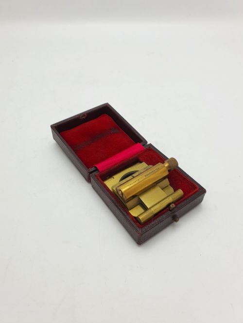 fig 1. A vintage Edwardian folding brass linen tester loupe with a glass lens and measuring scale engraved on the base plate.