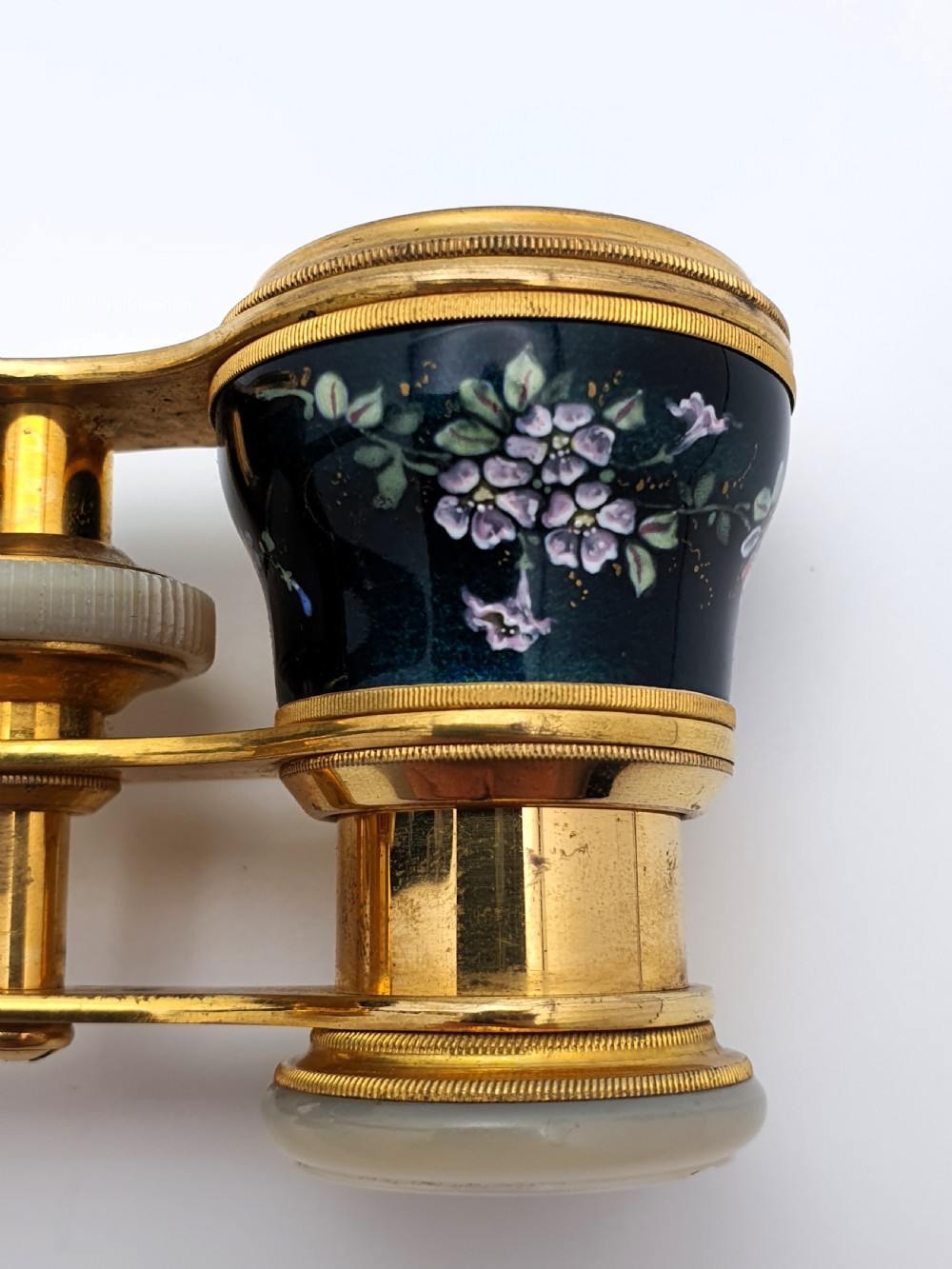 Edwardian opera glasses featuring black enamelled barrels with hand-painted floral patterns, mother of pearl eyepieces, lacquered brass fittings, and an extendable side handle. View VII