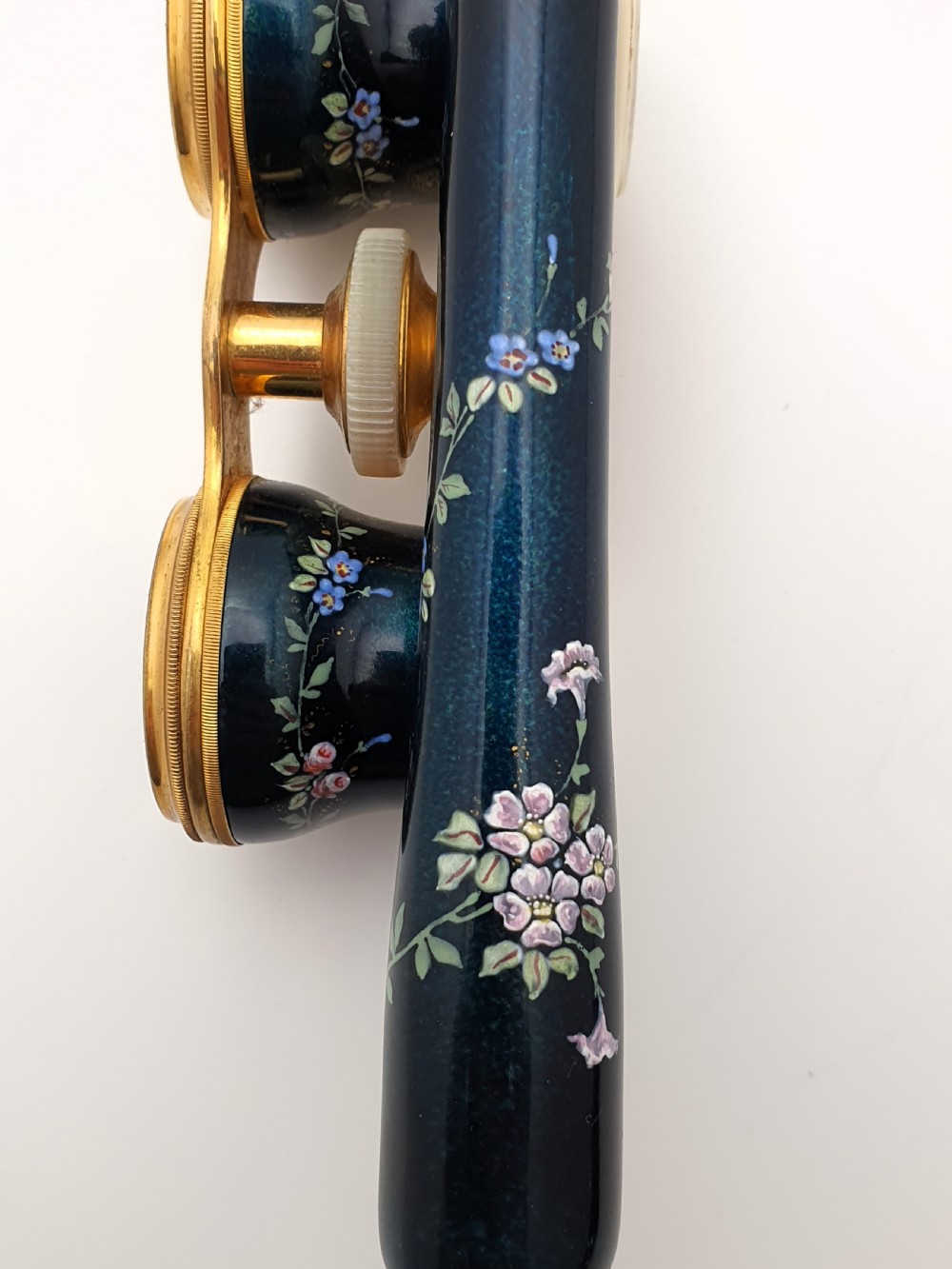 Edwardian opera glasses featuring black enamelled barrels with hand-painted floral patterns, mother of pearl eyepieces, lacquered brass fittings, and an extendable side handle. View XI