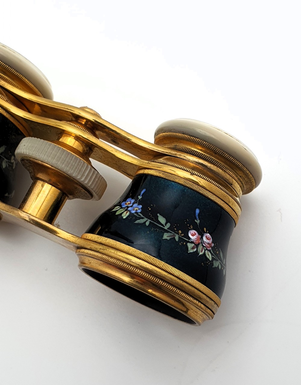 Edwardian opera glasses featuring black enamelled barrels with hand-painted floral patterns, mother of pearl eyepieces, lacquered brass fittings, and an extendable side handle. View XII