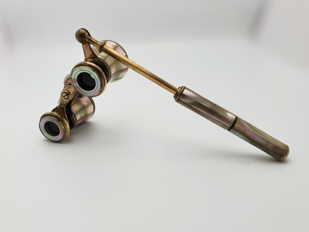 Victorian brass opera glasses featuring iridescent mother of pearl panels on the barrels and an extendable handle. View IX