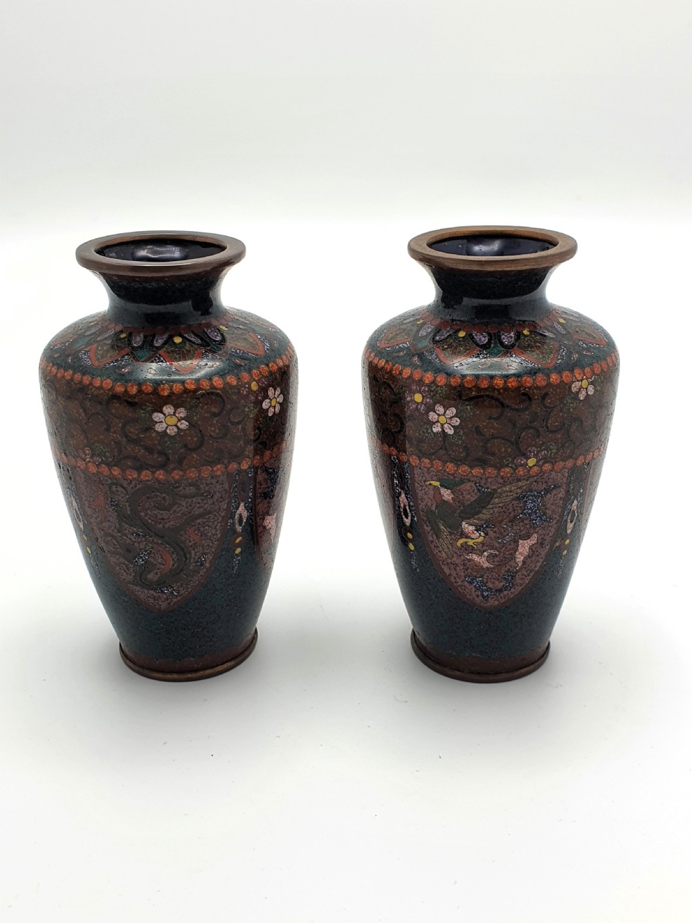 A pair of small dark brown Japanese cloisonne enamel vases decorated with bird and floral motifs. View II