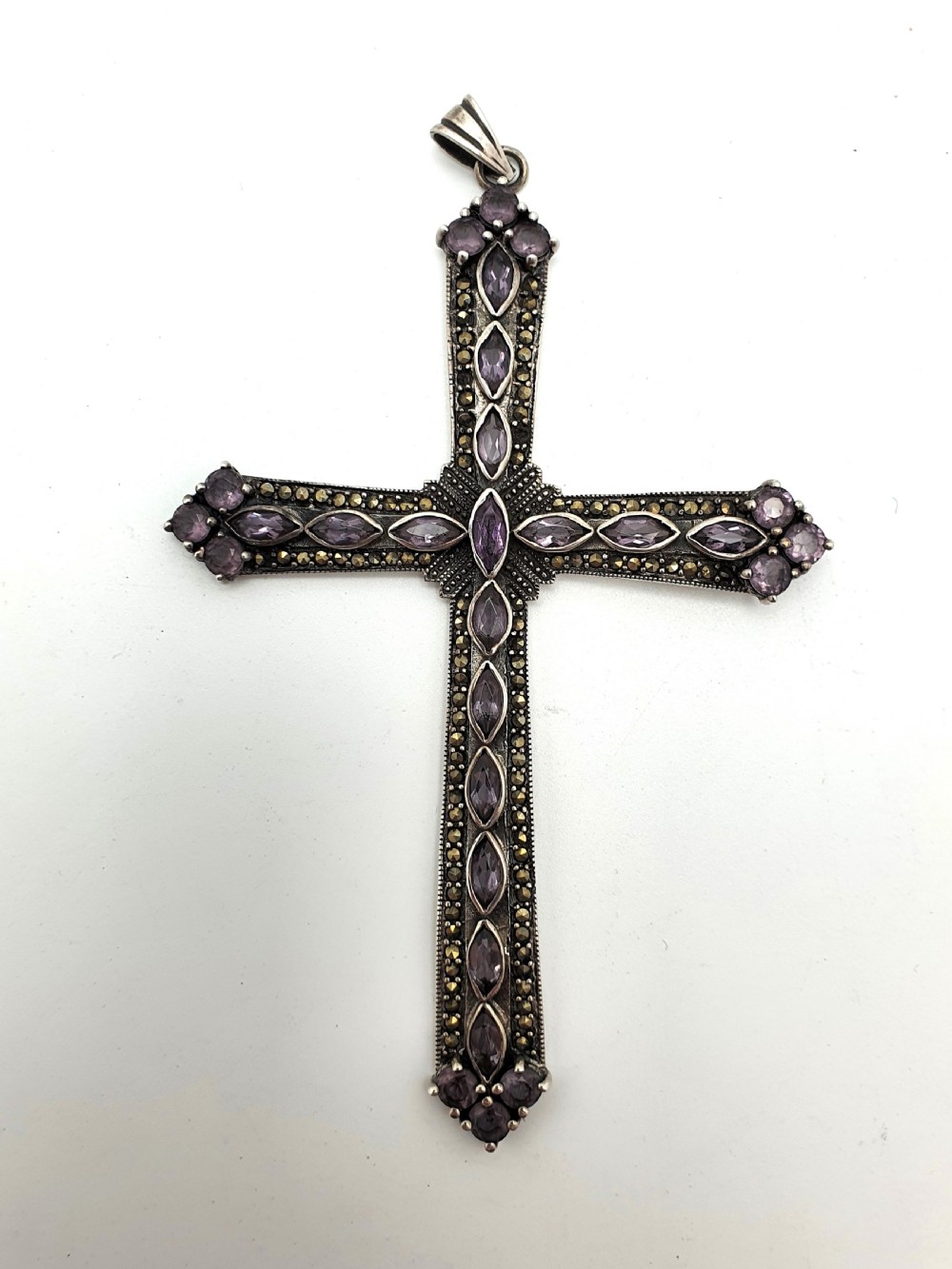 A silver cross pendant set with marquise-cut purple amethysts and detailed marcasite stones. View II