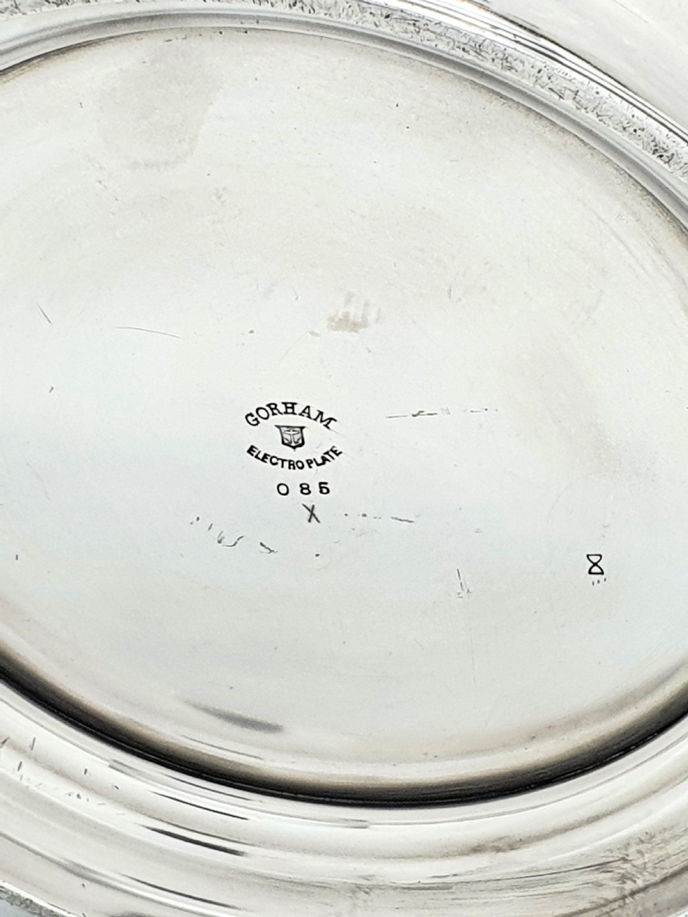 A silver-plated champagne bucket featuring twin side handles, a moulded rim, and an engraved script monogram on the front. View VI