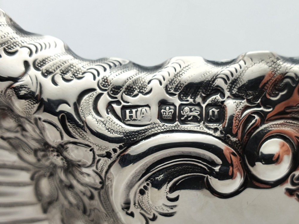 An Edwardian sterling silver shell-shaped serving dish featuring intricate pierced filigree patterns and chased floral relief along the rim. View III
